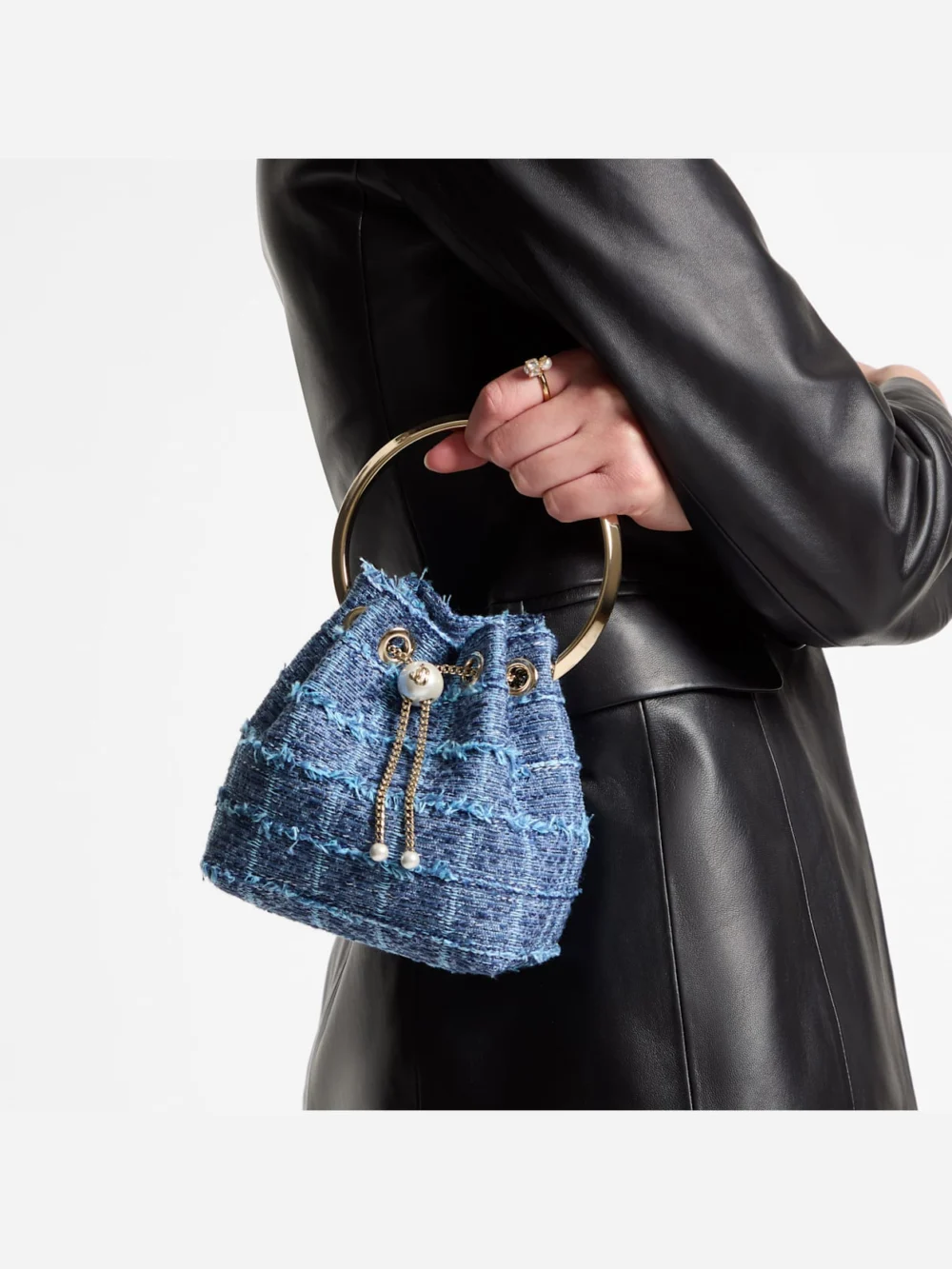 Side view of the Jimmy Choo Bon Bon Crosshatch Denim Fabric Bucket Bag