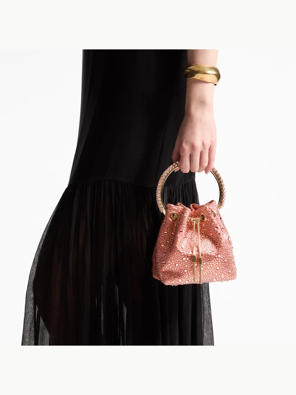 Side view of the Jimmy Choo Bon Bon Grapefruit Satin Bucket Bag with Crystal Embellishment and Crystal Handle