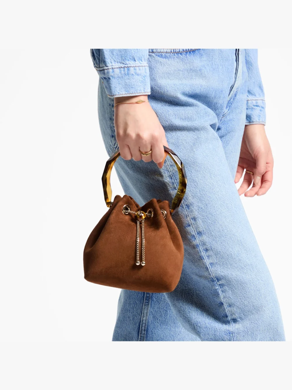 Side view of the Jimmy Choo Bon Bon Tan Suede Bucket Bag with Bead Closure and Tortoiseshell Handle