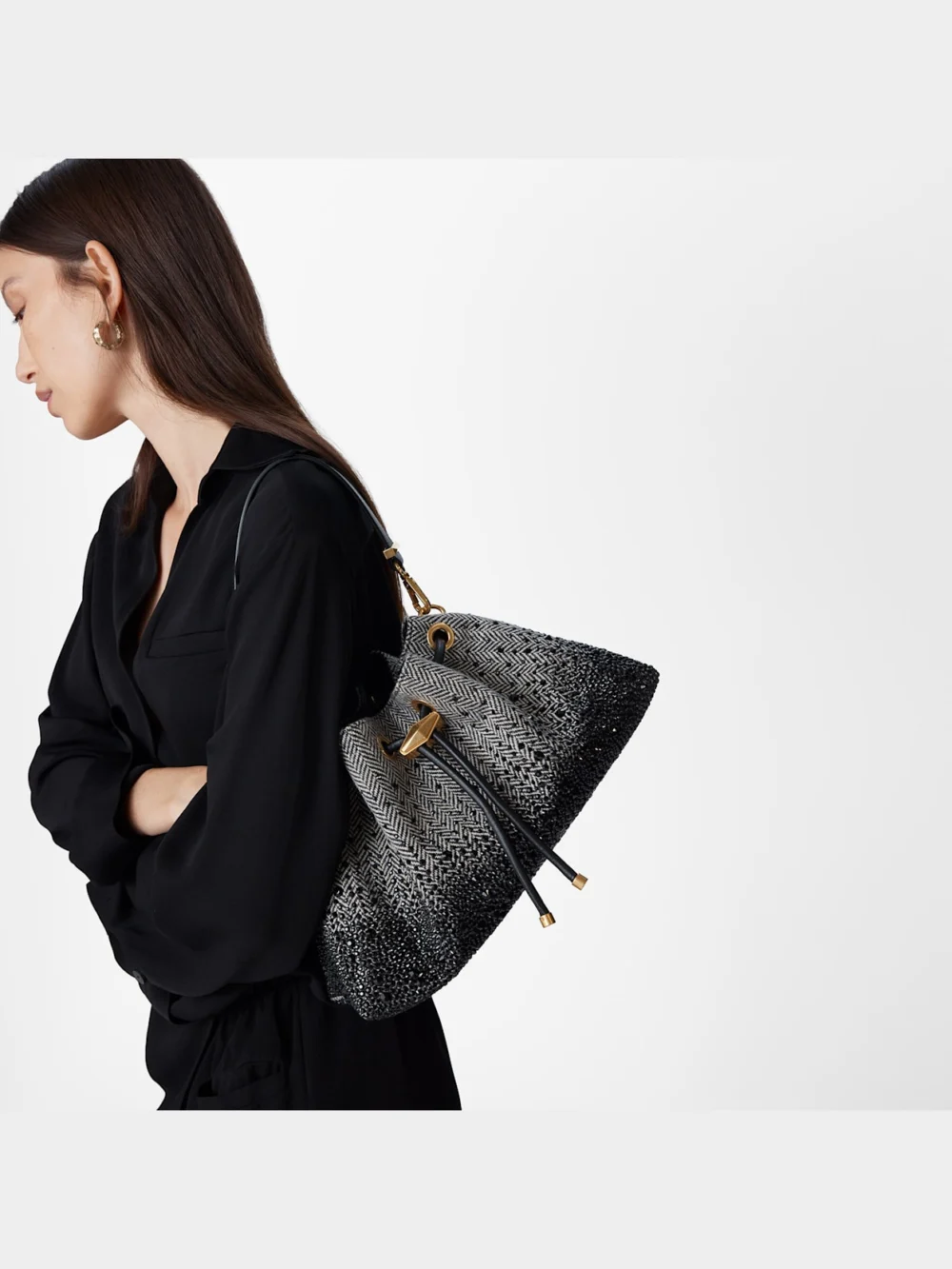 Close-up detail of the Jimmy Choo Cinch Medium Black and Bamboo Mix Herringbone Fabric Shoulder Bag with Crystal Hotfix
