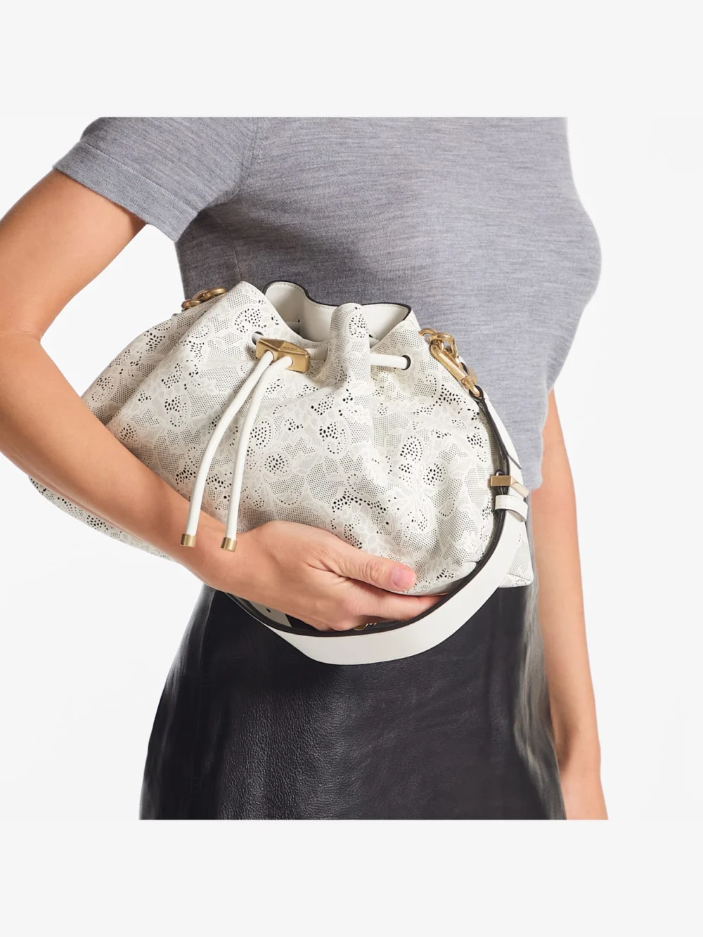 Side view of the Jimmy Choo Cinch Medium Latte Perforated Lace Shoulder Bag