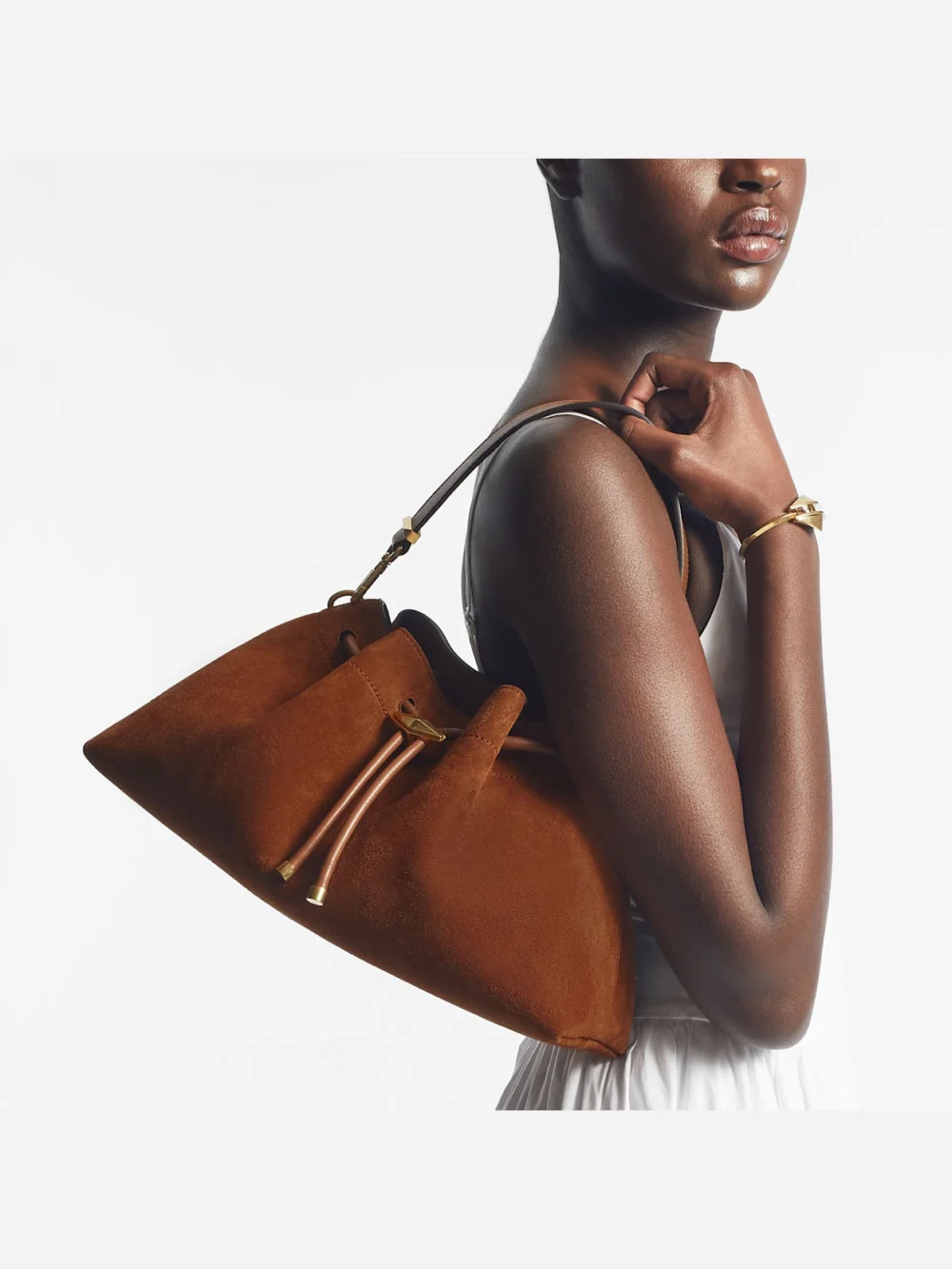 Close-up detail of the Jimmy Choo Cinch Medium Tan Suede Shoulder Bag