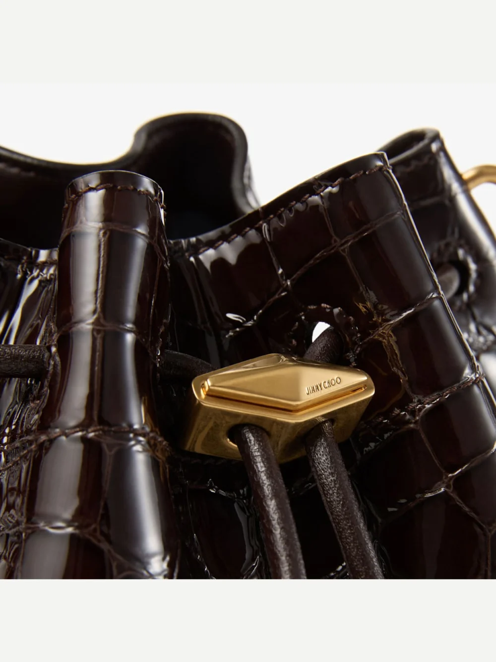 Close-up detail of the Jimmy Choo Cinch Small Sambuco Shiny Croc Embossed Leather Shoulder Bag