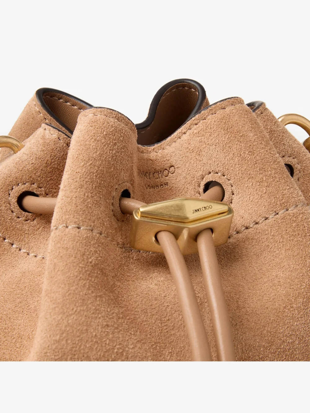 Close-up detail of the Jimmy Choo Cinch Small Toffee Suede Shoulder Bag