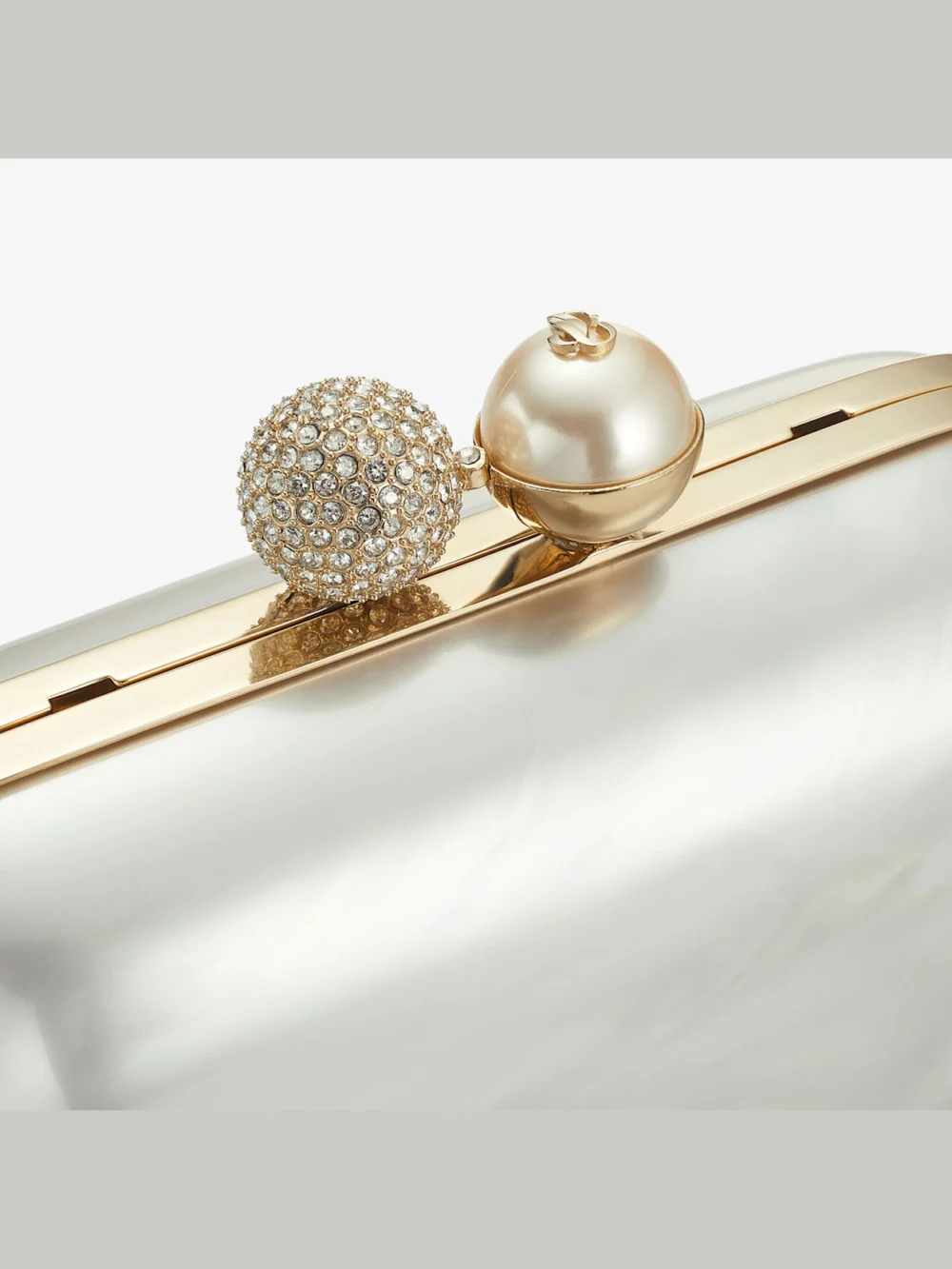 Close-up detail of the Jimmy Choo Cloud Ivory Mother of Pearl Clutch Bag with Crystal Clasp