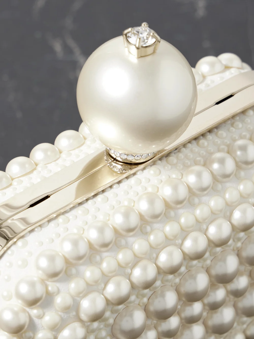 Close-up detail of the Jimmy Choo Cloud Micro Embellished Satin Clutch