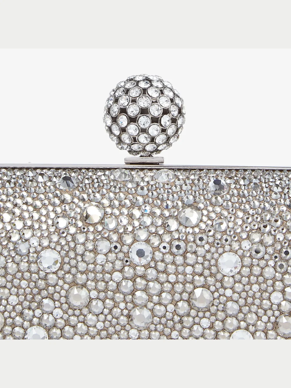 Close-up detail of the Jimmy Choo Cloud Nude Shimmer Suede Clutch Bag with Hotfix and Crystal Encrusted Sphere Clasp
