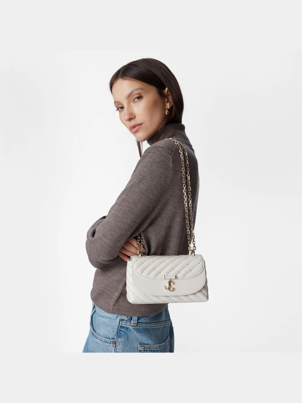 Close-up detail of the Jimmy Choo Curve Crossbody Small Latte Quilted Nappa Leather Crossbody Bag