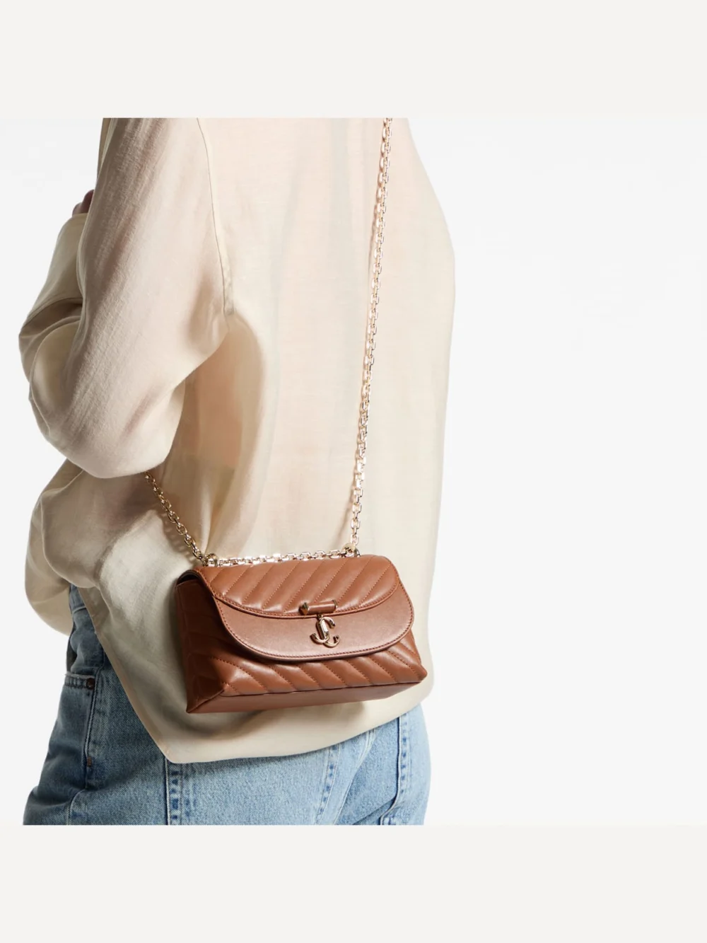 Side view of the Jimmy Choo Curve Crossbody Small Tan Quilted Biker Leather Crossbody Bag