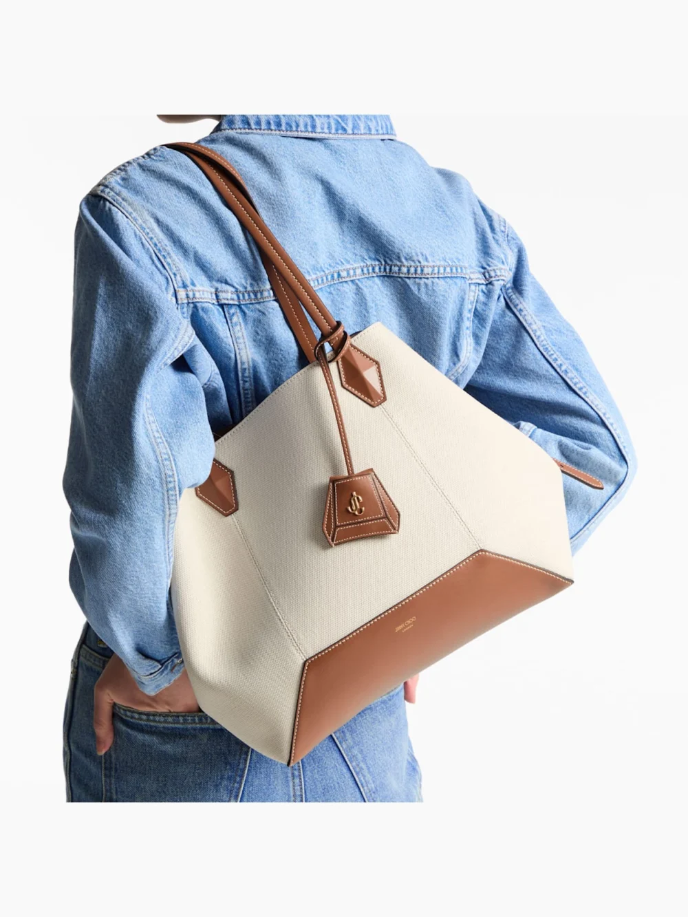 Side view of the Jimmy Choo Diamond Tote Medium Natural and Tan Recycled Canvas Tote Bag with Leather Trim