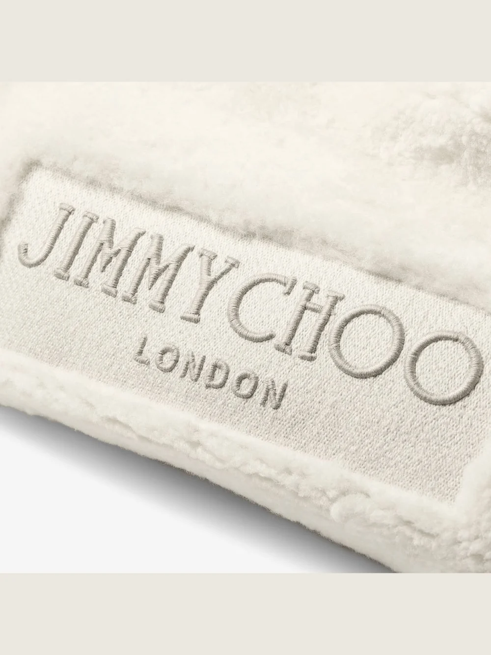 Close-up detail of the Jimmy Choo Drawstring Tote Medium Natural Shearling Drawstring Tote with Leather Trims