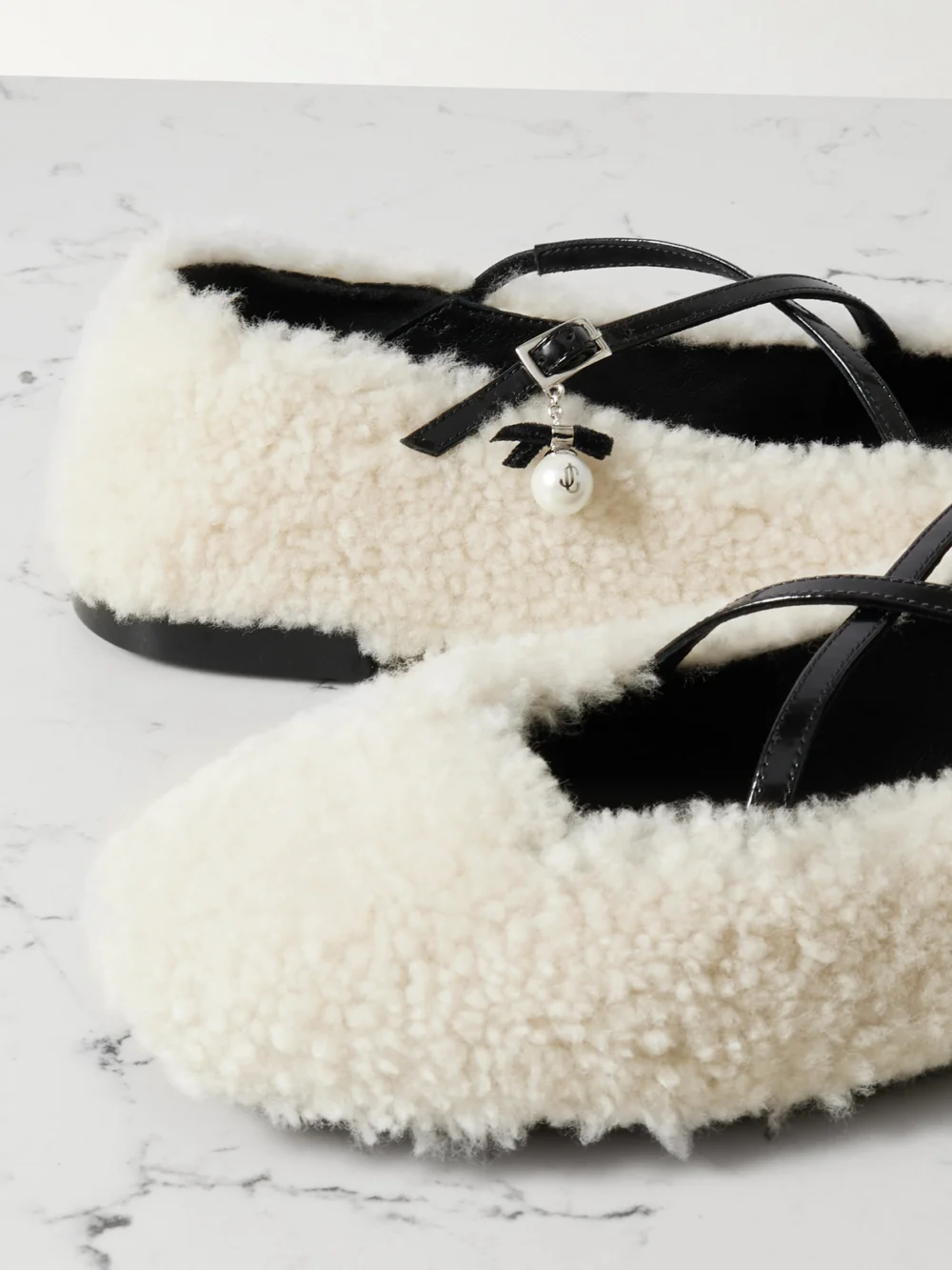 Close-up detail of the Jimmy Choo Eleri Embellished Patent Leather-trimmed Shearling Ballet Flats