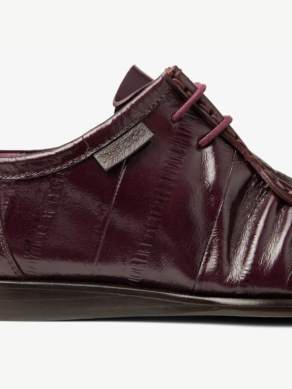 Close-up detail of the Jimmy Choo Ember Moccasin F Deep Merlot Eel Embossed Leather Moccasins