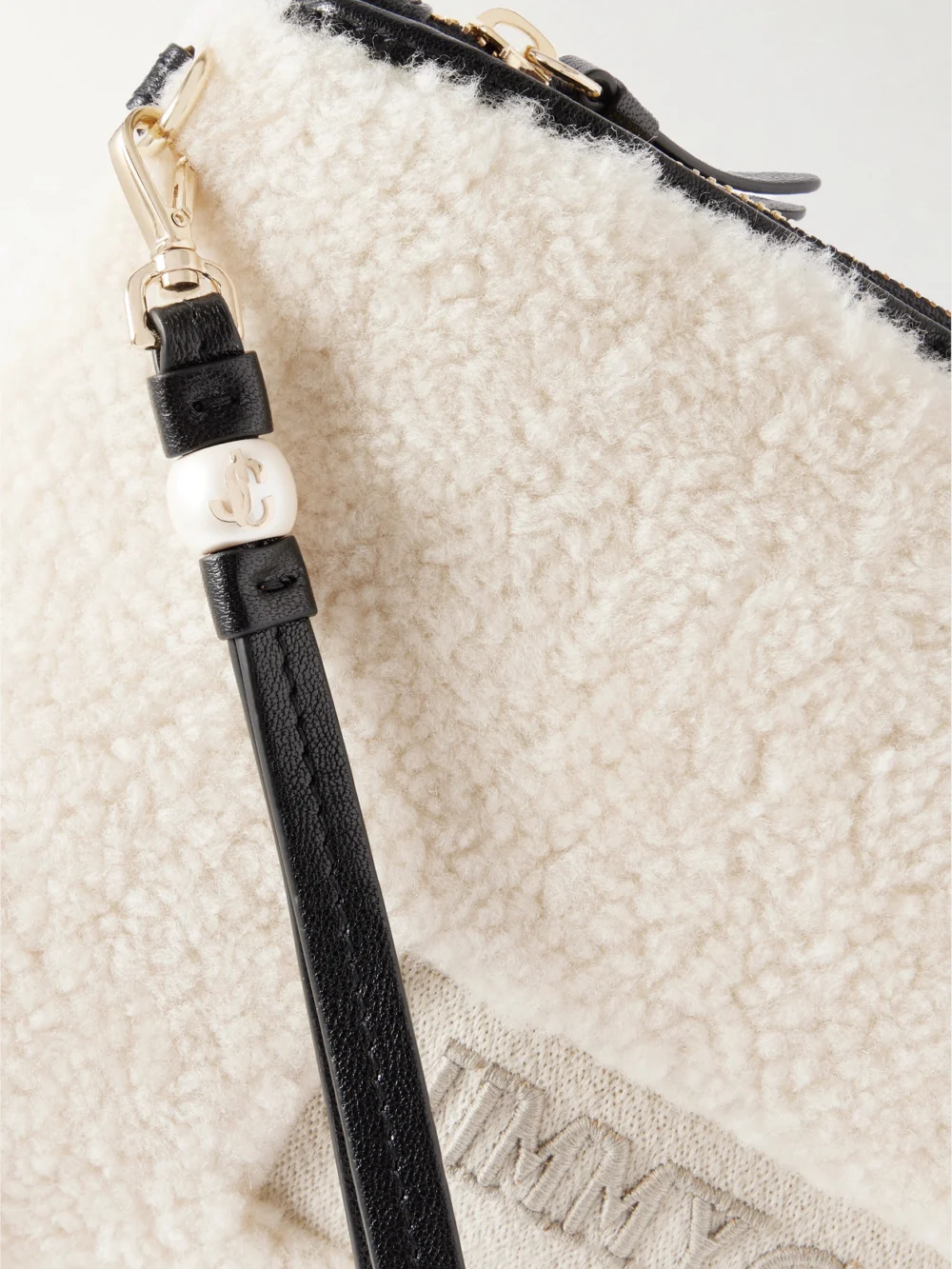 Close-up detail of the Jimmy Choo Embroidered Leather-trimmed Shearling Clutch