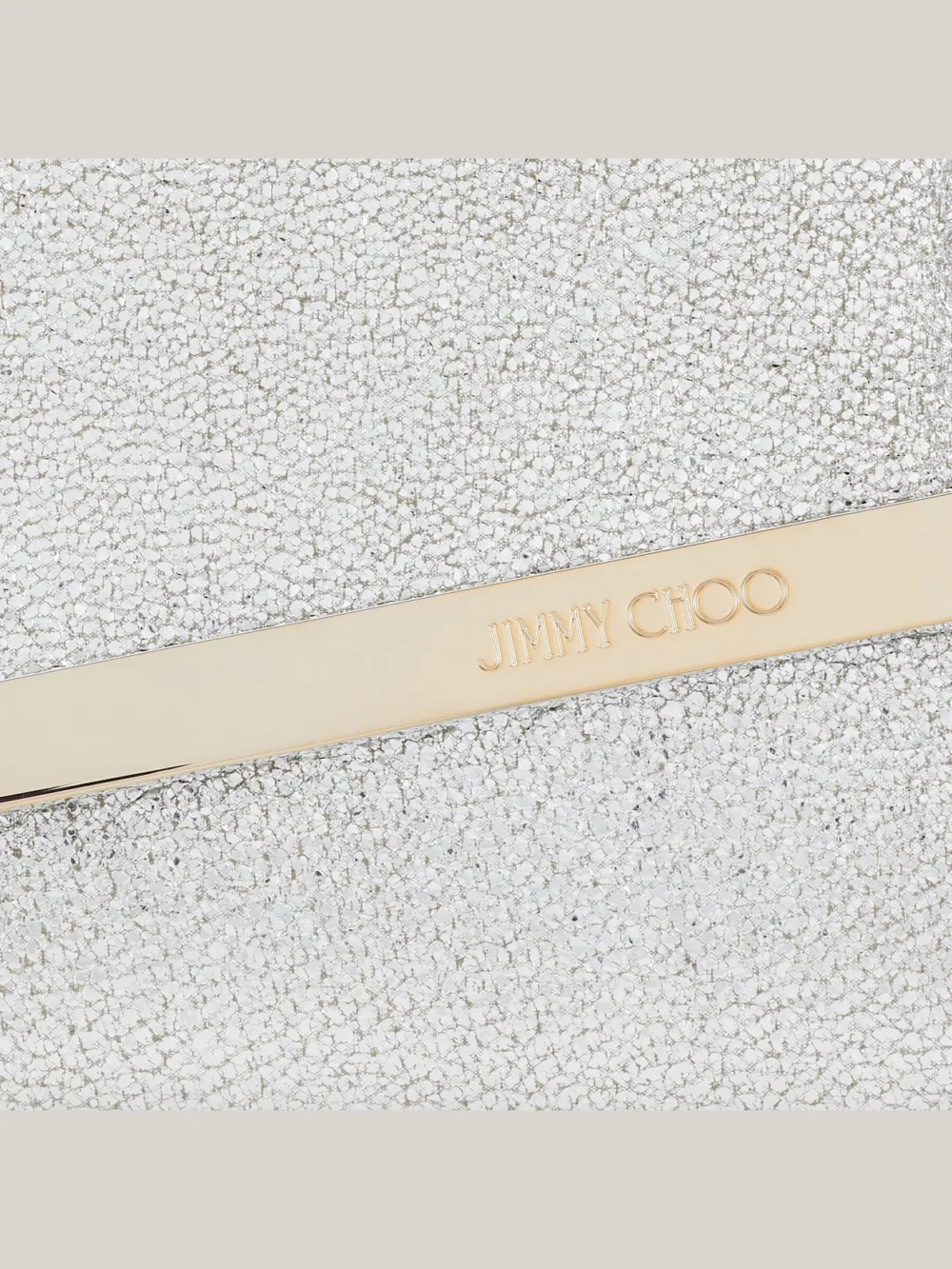 Close-up detail of the Jimmy Choo Emmie Champagne Glitter Leather Clutch Bag