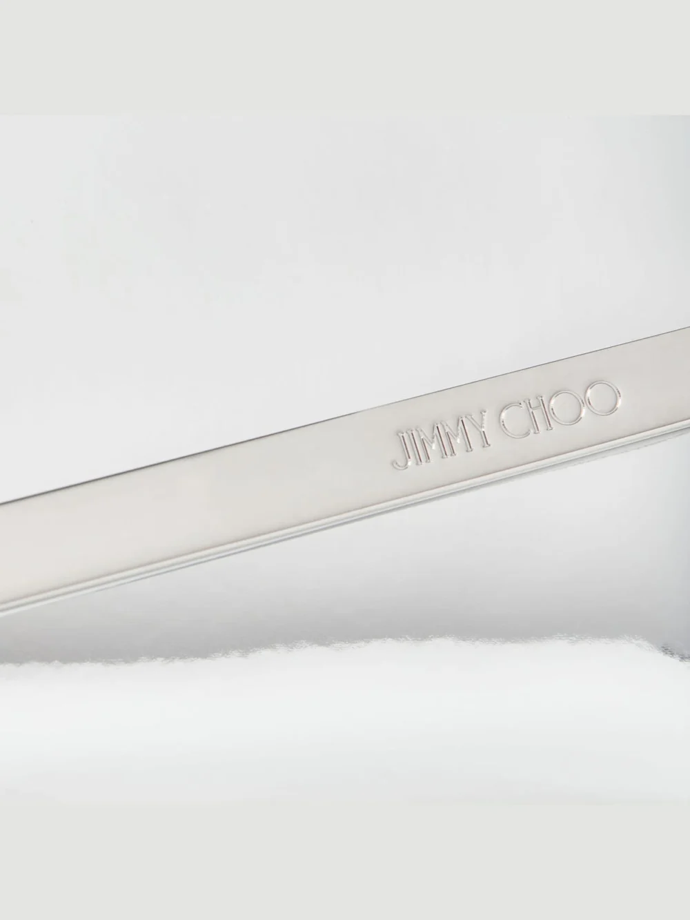 Close-up detail of the Jimmy Choo Emmie Silver Mirror Fabric Clutch Bag