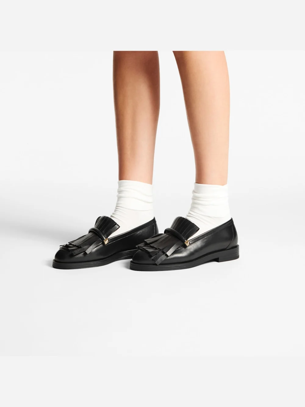 Side view of the Jimmy Choo Eska Loafer Black Leather Loafers with Fringed Detail