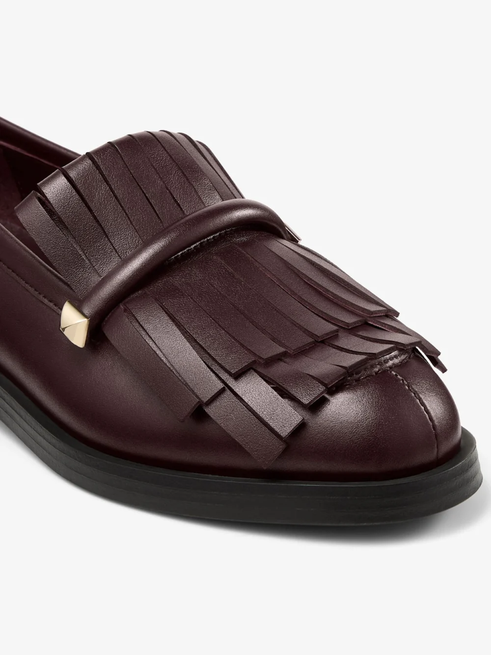 Close-up detail of the Jimmy Choo Eska Loafer Deep Merlot Leather Loafers with Fringed Detail