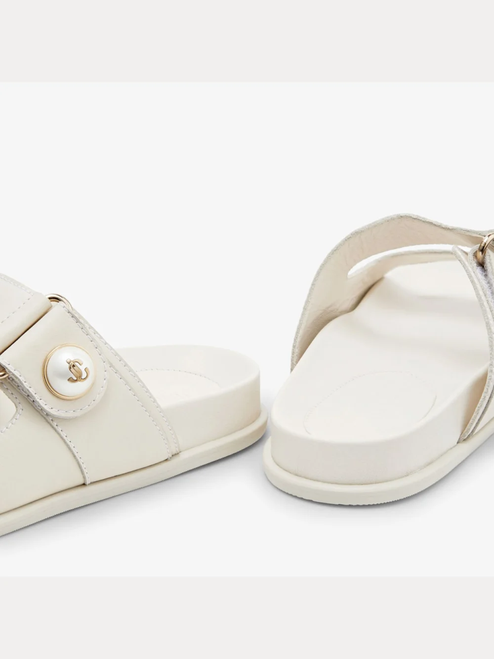 Close-up detail of the Jimmy Choo Fayence Sandal Latte Leather Flat Sandals with Pearl Embellishment