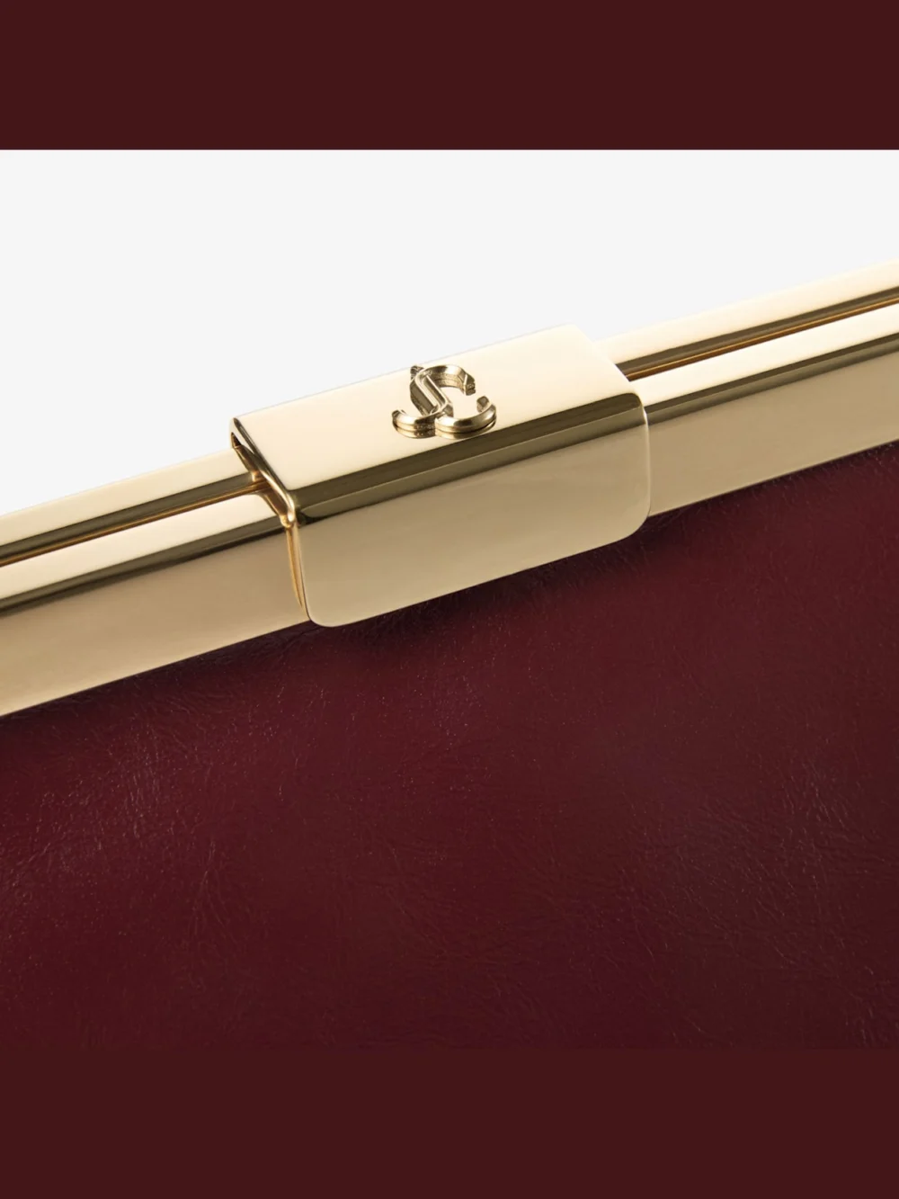 Close-up detail of the Jimmy Choo Ganache Cherry and Gold Soft Shiny Biker Leather Clutch Bag