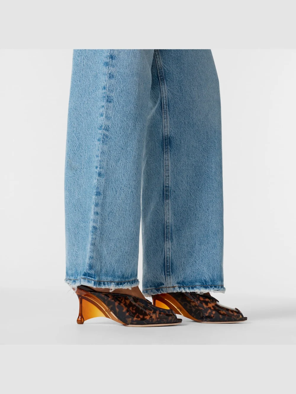 Side view of the Jimmy Choo Glace Mule 80 Amber and Brown Mix Tortoiseshell Tpu Sandals with Plexy Wedge