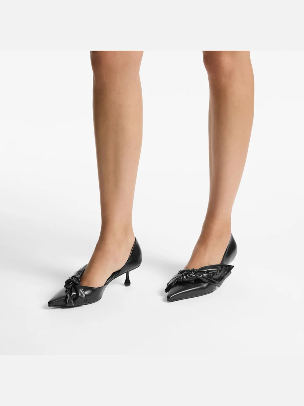 Side view of the Jimmy Choo Issy Pump 50 Black Leather Pumps with Oversized Bow