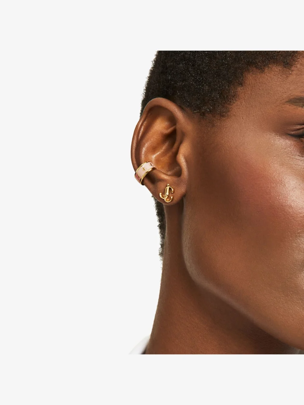 Close-up detail of the Jimmy Choo Jc Mini Studs Gold Finish Metal Jc Mini Stud Earrings