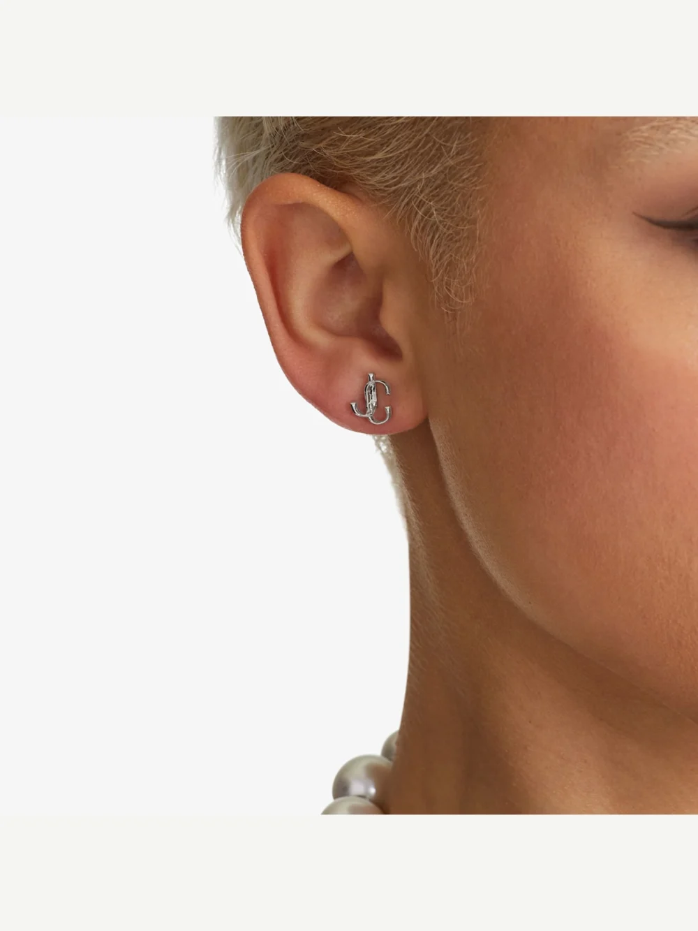 Close-up detail of the Jimmy Choo Jc Mini Studs Silver Finish Metal Jc Mini Stud Earrings