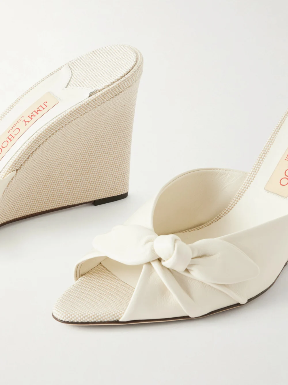 Close-up detail of the Jimmy Choo Livi 85 Bow-embellished Leather Wedge Sandals