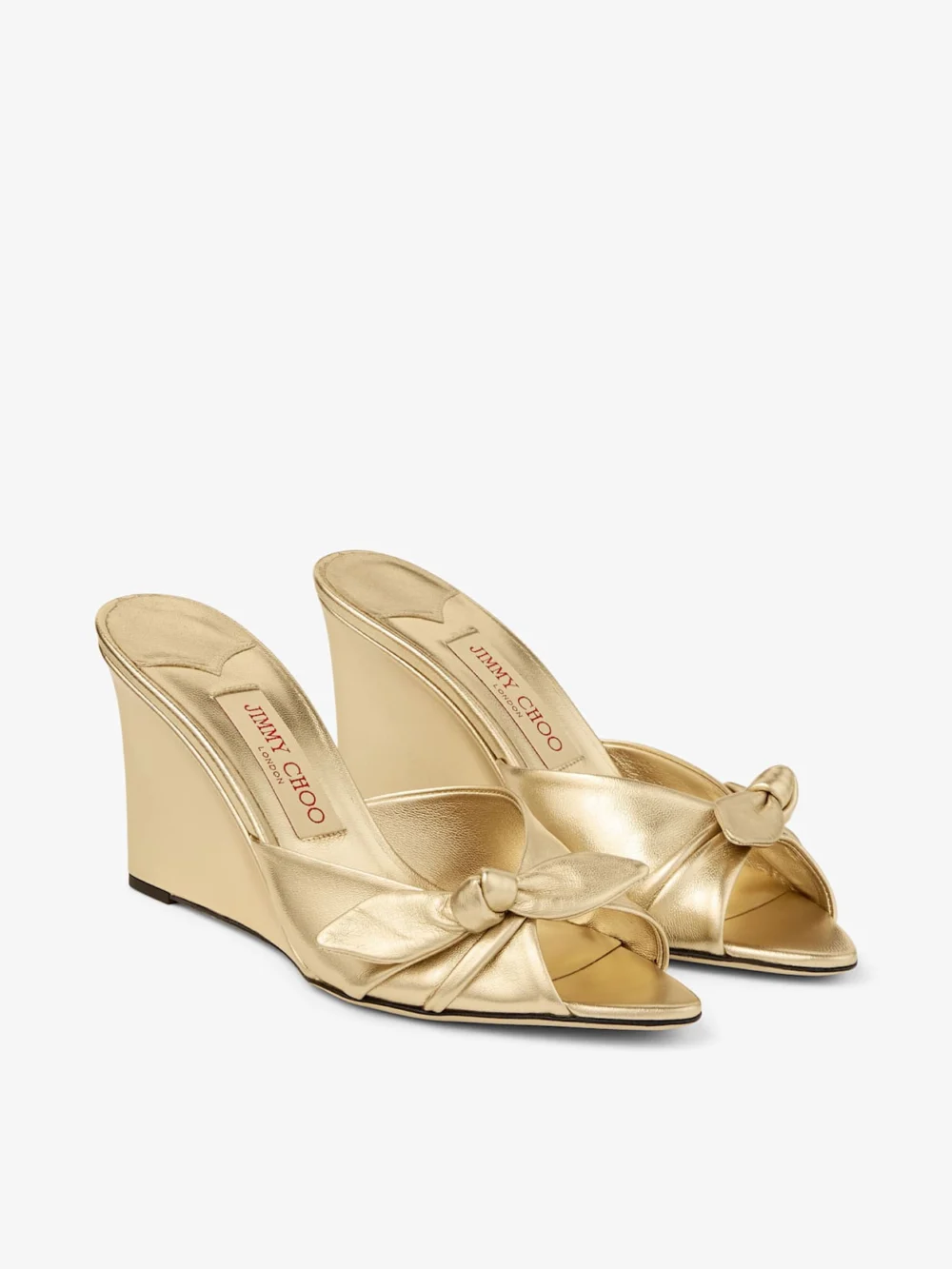 Close-up detail of the Jimmy Choo Livi Wedge 85 Gold Metallic Nappa Leather Mules Wedges with Bow