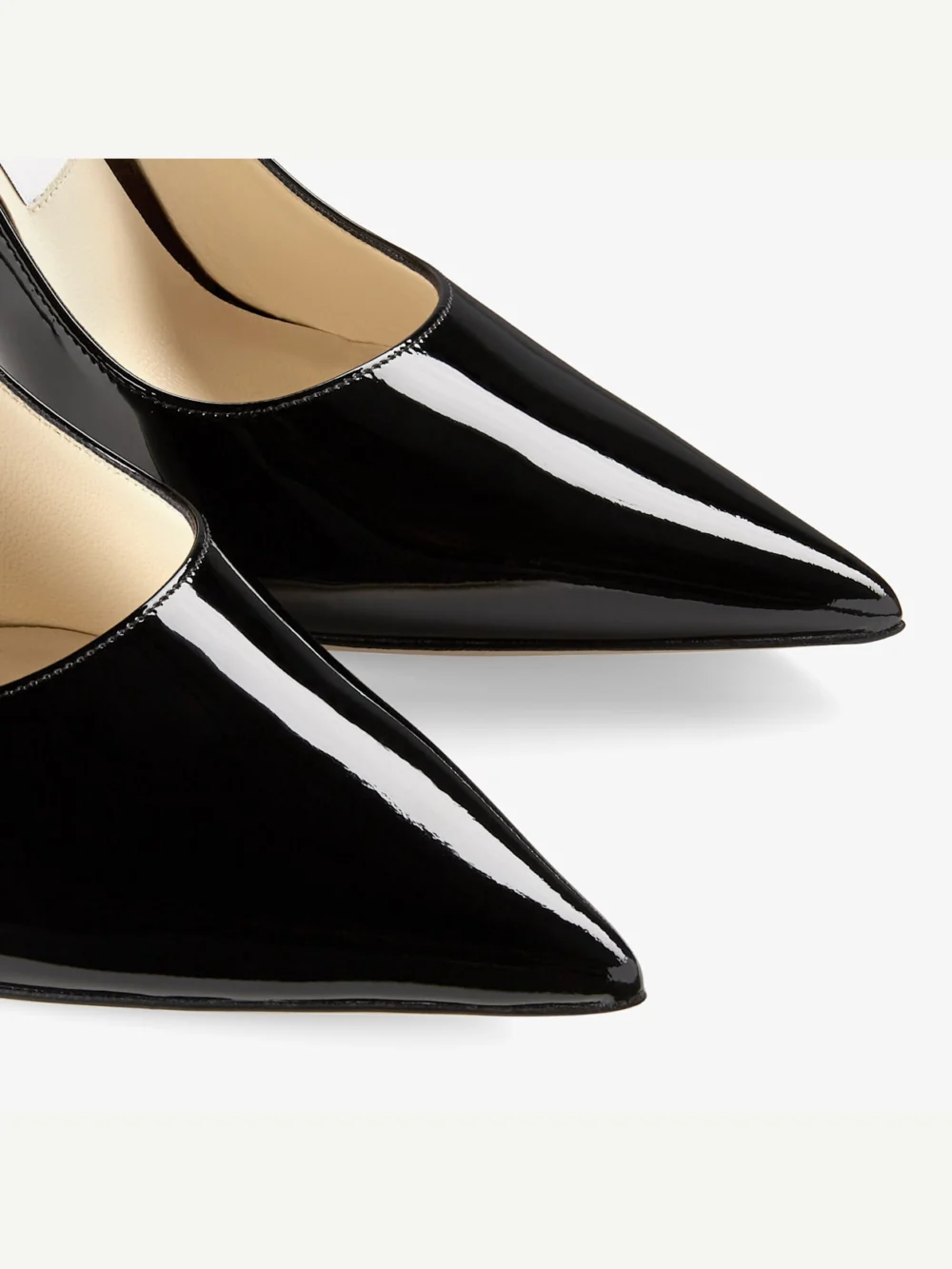 Close-up detail of the Jimmy Choo Love 100 Black Patent Leather Pointed Toe Pumps with Jc Emblem