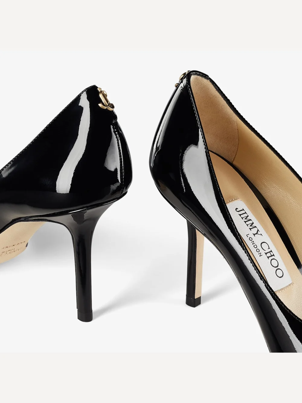Close-up detail of the Jimmy Choo Love 85 Black Patent Leather Pumps with Jc Emblem