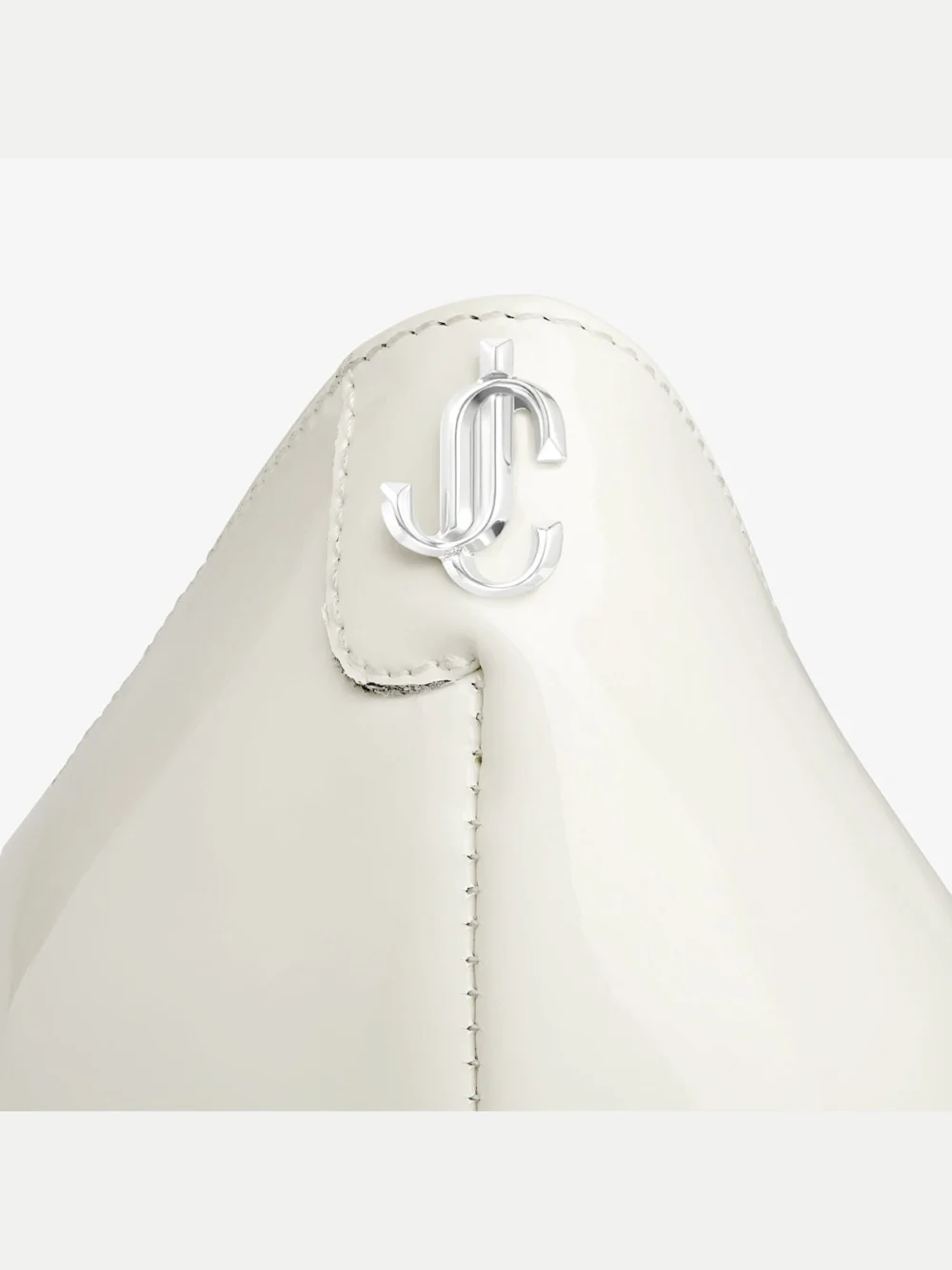 Close-up detail of the Jimmy Choo Love 85 Latte Patent Leather Pumps with Jc Emblem