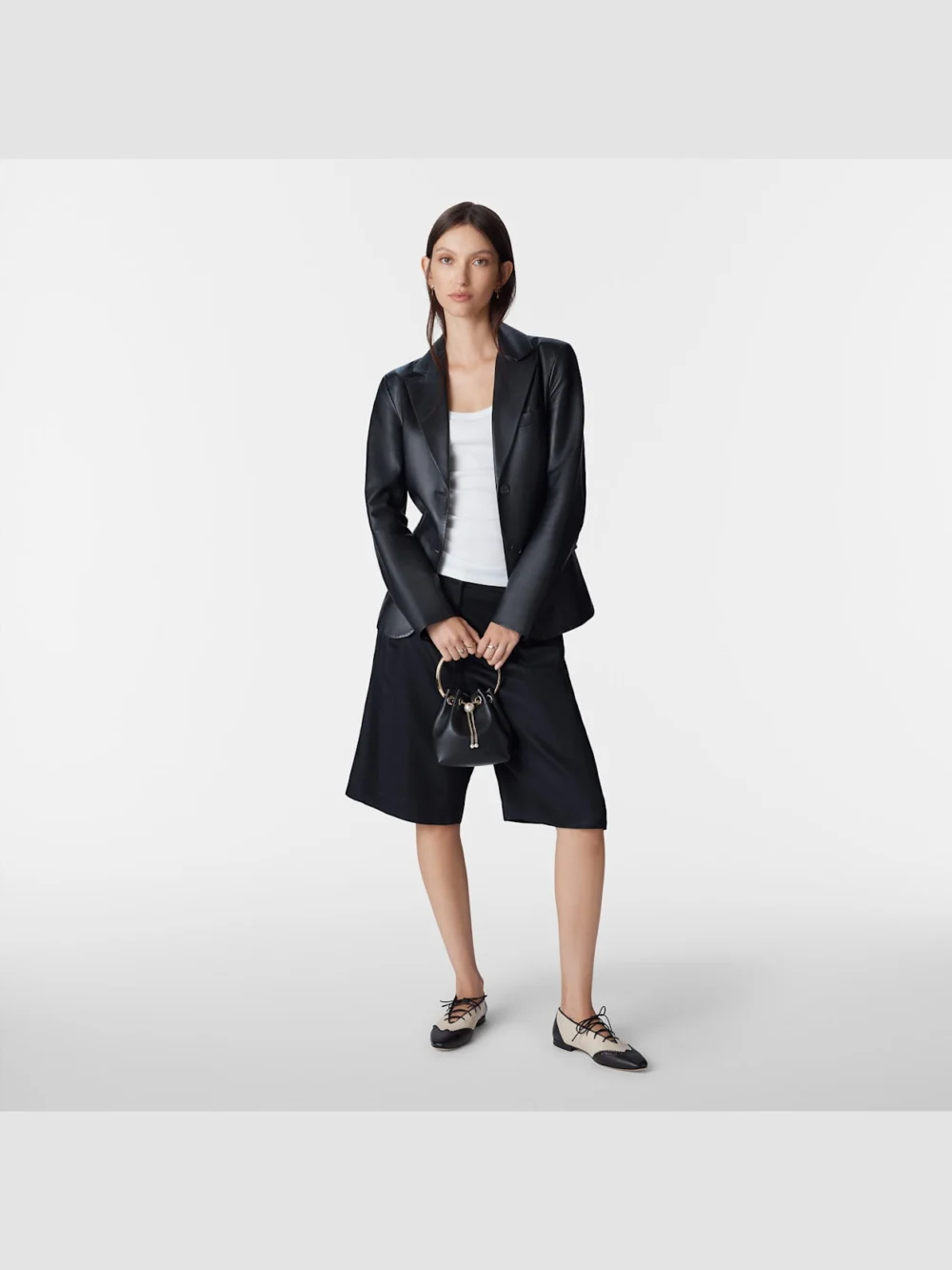 Side view of the Jimmy Choo Margot Lace Up Flat Black and Bone Nappa Leather Lace Up Flats with Broguing