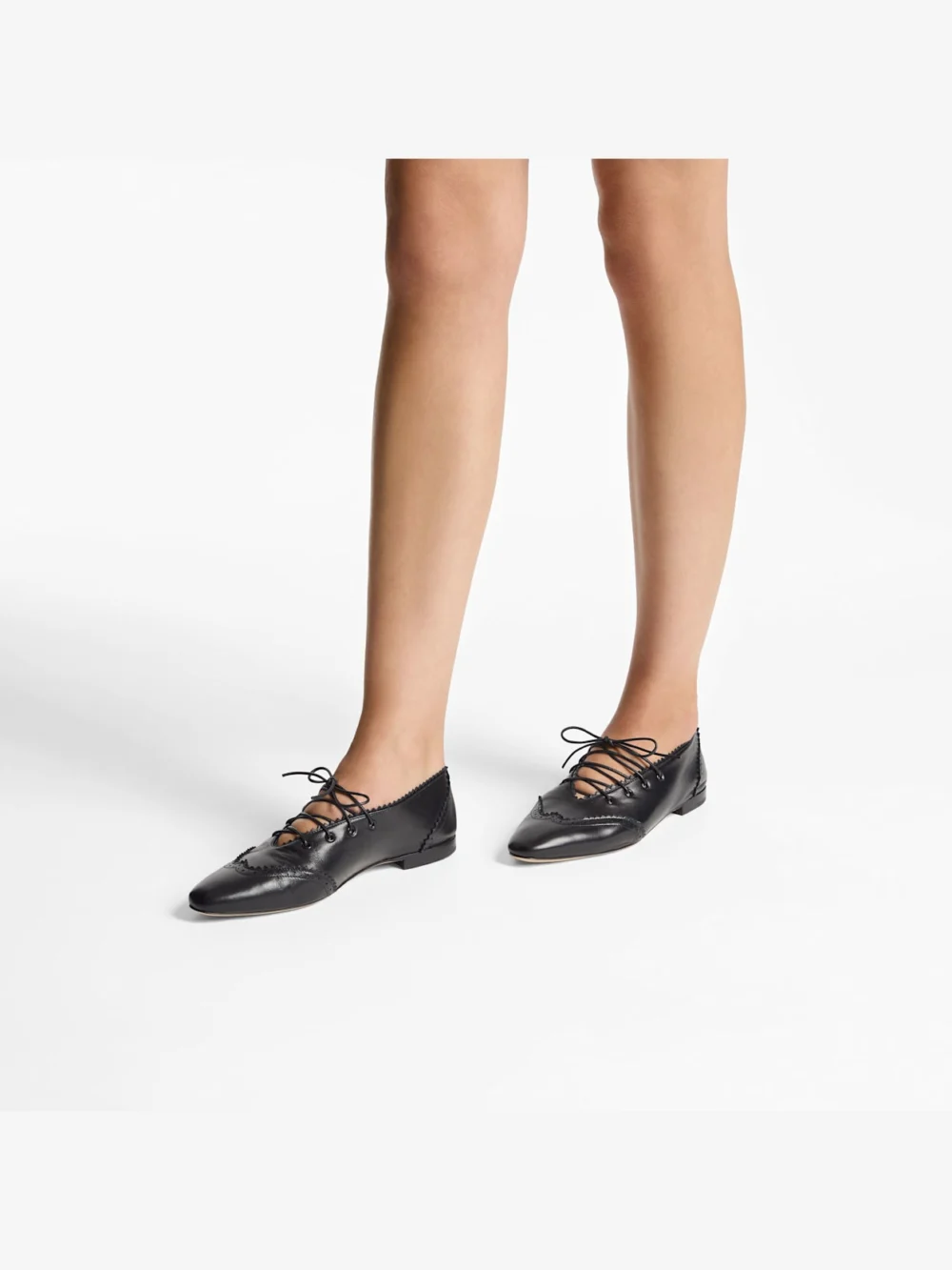 Side view of the Jimmy Choo Margot Lace Up Flat Black Leather Lace Up Flats with Brogue Detailing