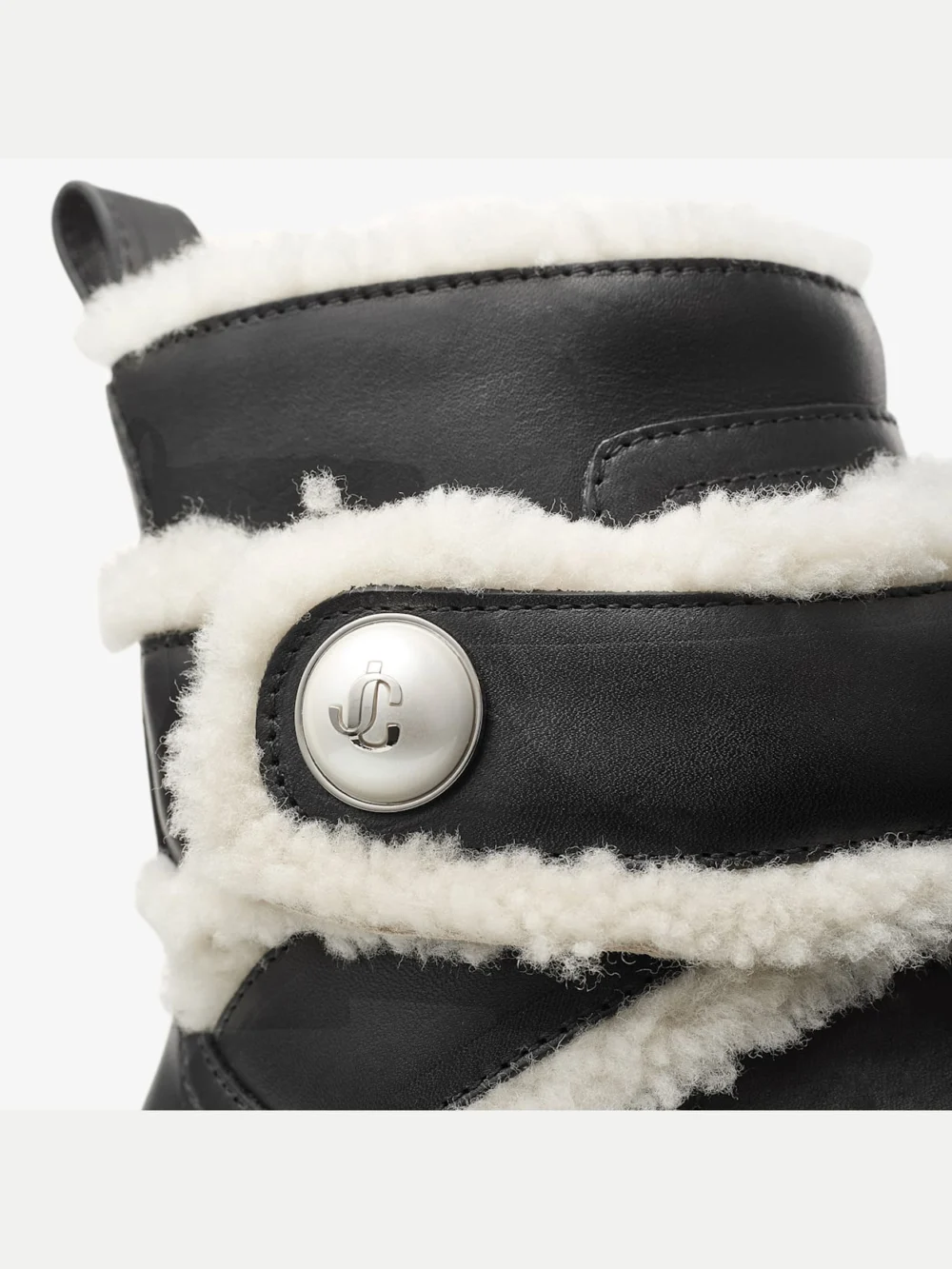 Back view of the Jimmy Choo Meena Flat Black Shiny Calf Leather Ankle Boots with Shearling