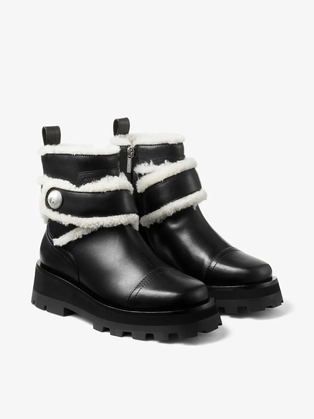 Close-up detail of the Jimmy Choo Meena Flat Black Shiny Calf Leather Ankle Boots with Shearling