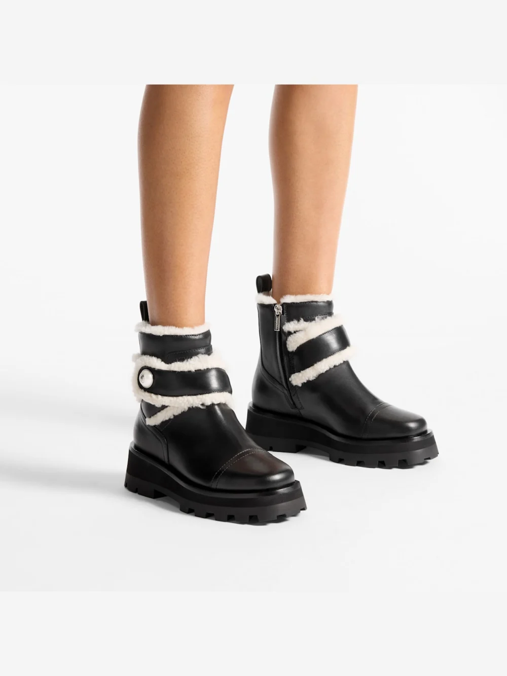 Side view of the Jimmy Choo Meena Flat Black Shiny Calf Leather Ankle Boots with Shearling