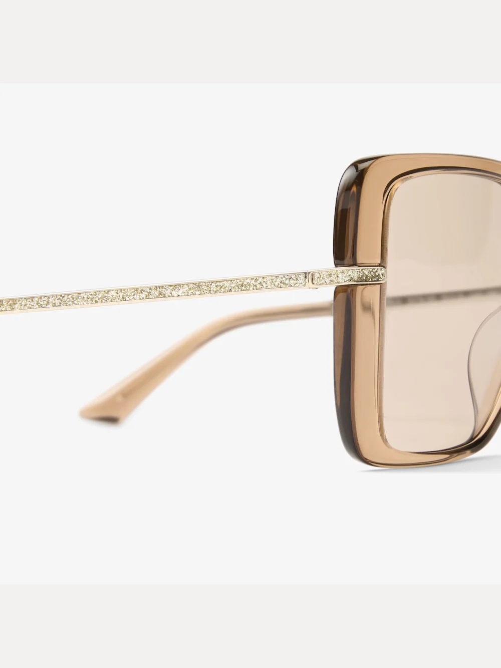Close-up detail of the Jimmy Choo Pati Transparent Tan Square Sunglasses