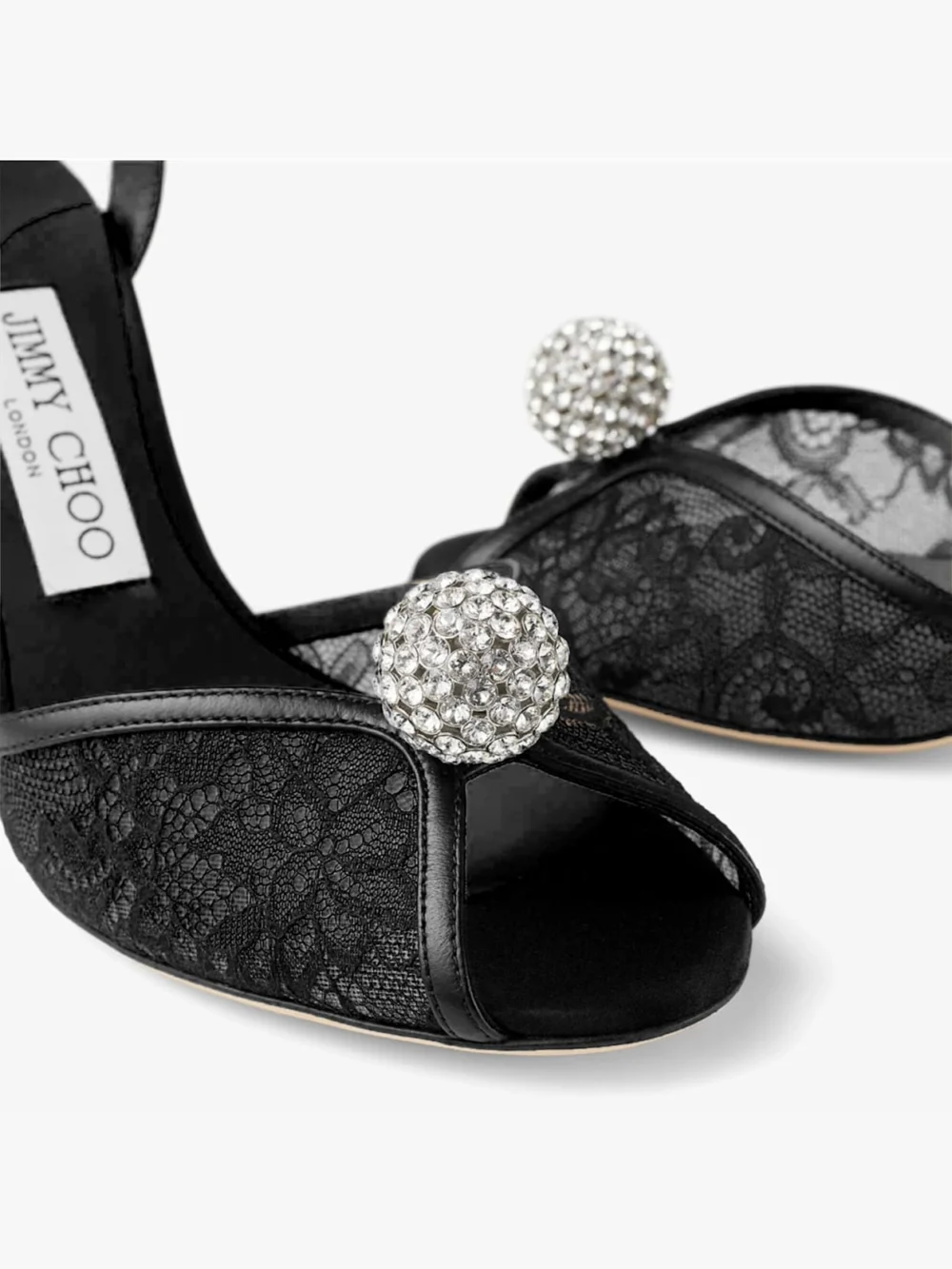Close-up detail of the Jimmy Choo Sacora 85 Black Lace Sandals with Crystal Embellished Sphere