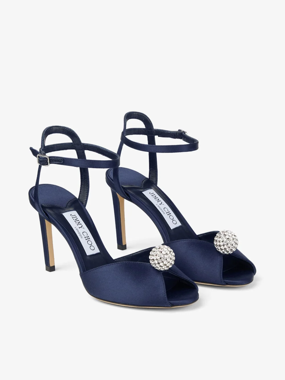 Close-up detail of the Jimmy Choo Sacora 85 Marine Satin Sandals with Crystal Embellished Sphere