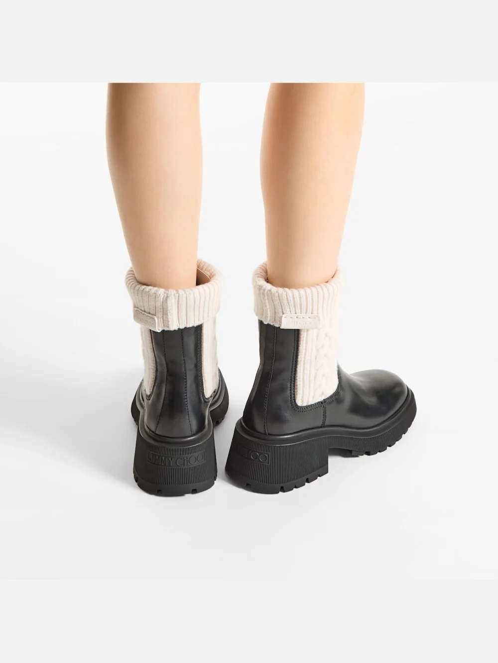 Side view of the Jimmy Choo Tamia Flat Black and Latte Shiny Calf Leather and Cable Knit Wool Chelsea Boots