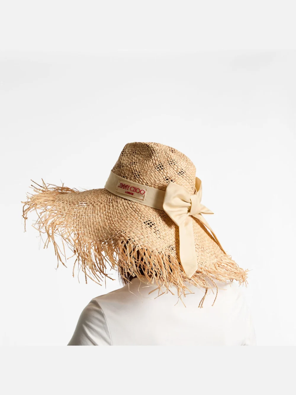 Side view of the Jimmy Choo Thalia Large Natural Raffia Hat with Ribbon Bow
