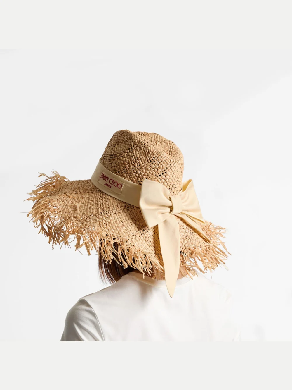 Side view of the Jimmy Choo Thalia Small Natural Raffia Hat with Ribbon Bow