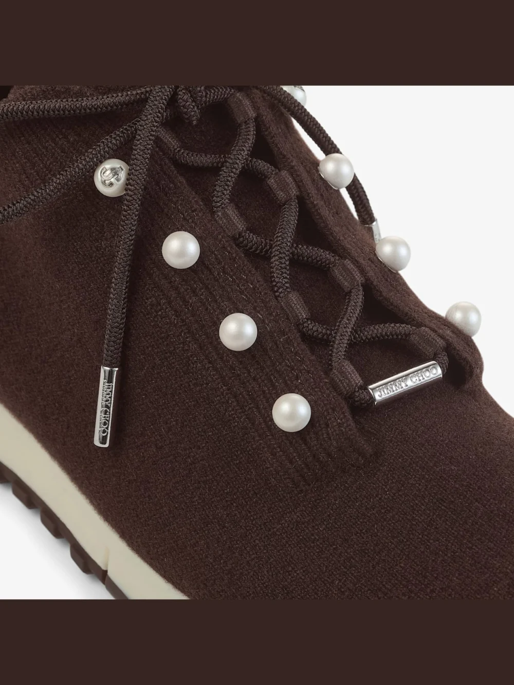 Close-up detail of the Jimmy Choo Veles Chocolate Cashmere Melange Knit Trainers with Pearl Buttons