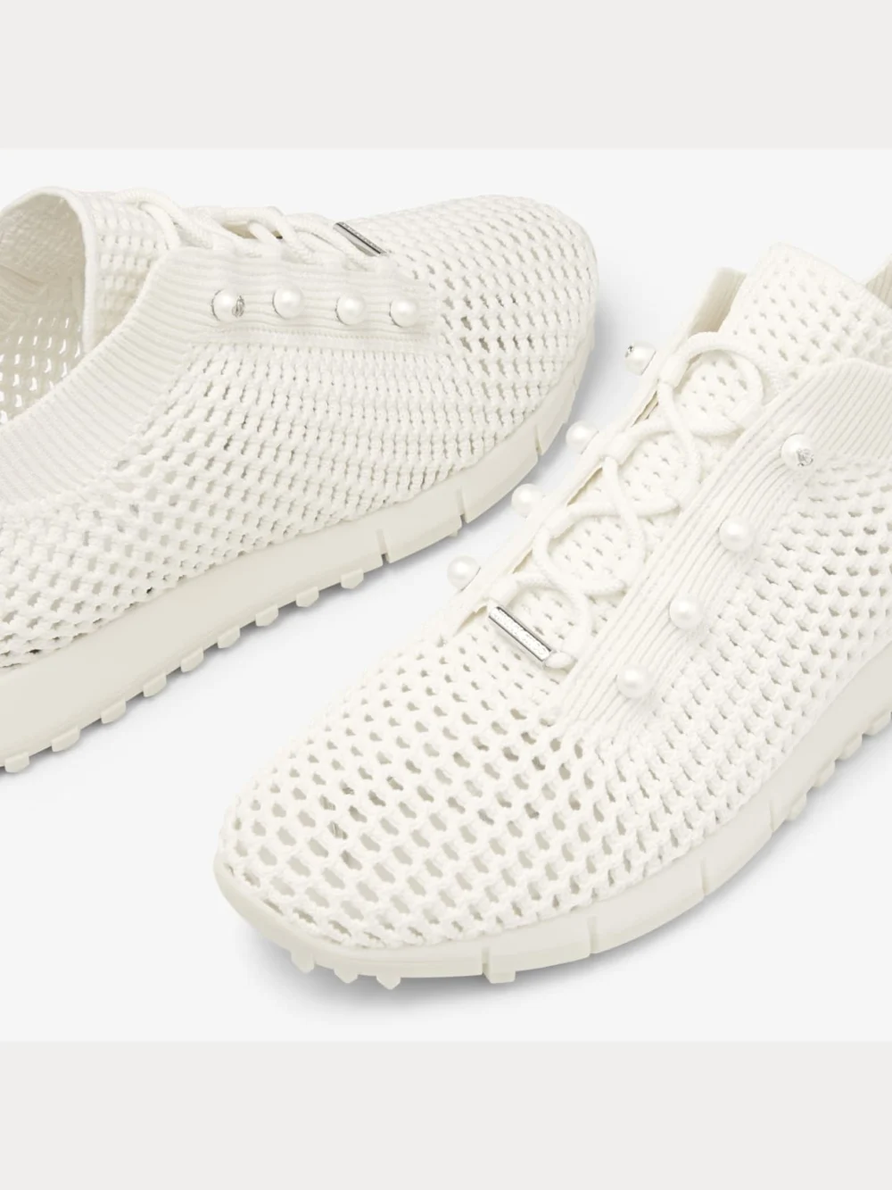 Close-up detail of the Jimmy Choo Veles Latte Crochet Knit Low Top Trainers with Pearls