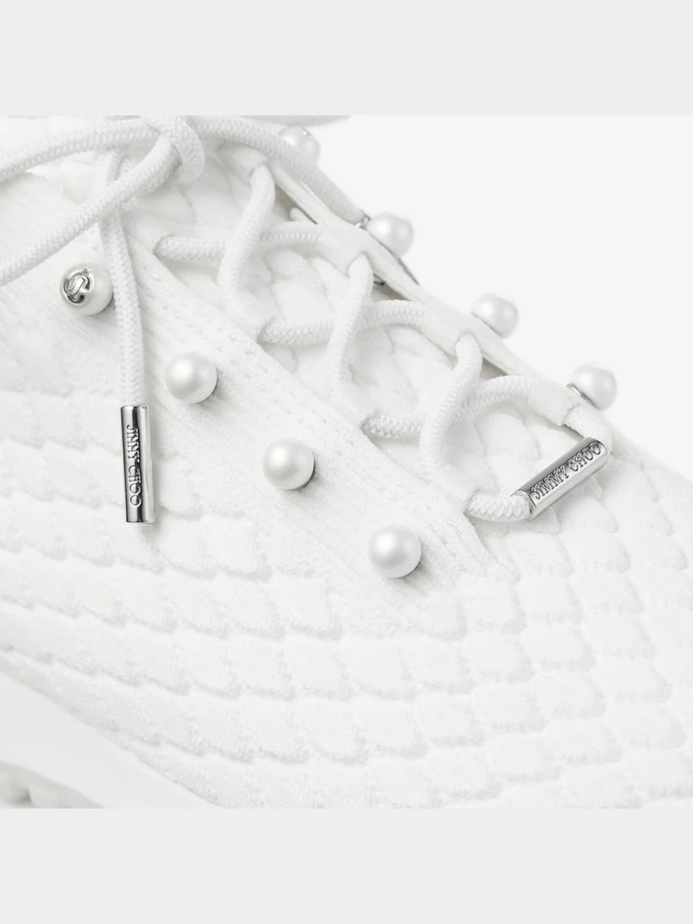 Close-up detail of the Jimmy Choo Veles White Textured Knit Trainers