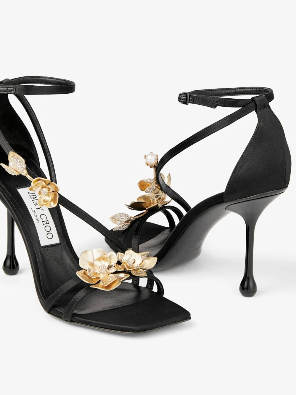Close-up detail of the Jimmy Choo Zea 95 Black Satin Sandals with Metal Flowers