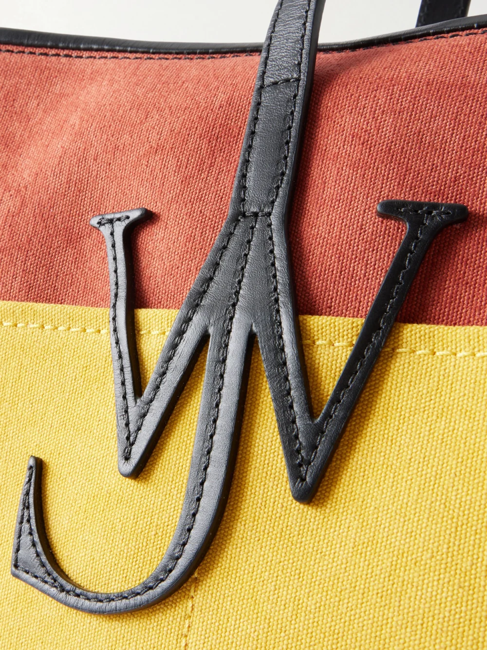 Close-up detail of the JW Anderson Anchor Striped Leather-trimmed Canvas Tote