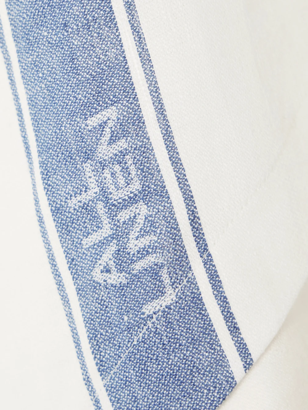 Close-up detail of the JW Anderson Asymmetric Linen-jacquard Mini Wrap-effect Skirt
